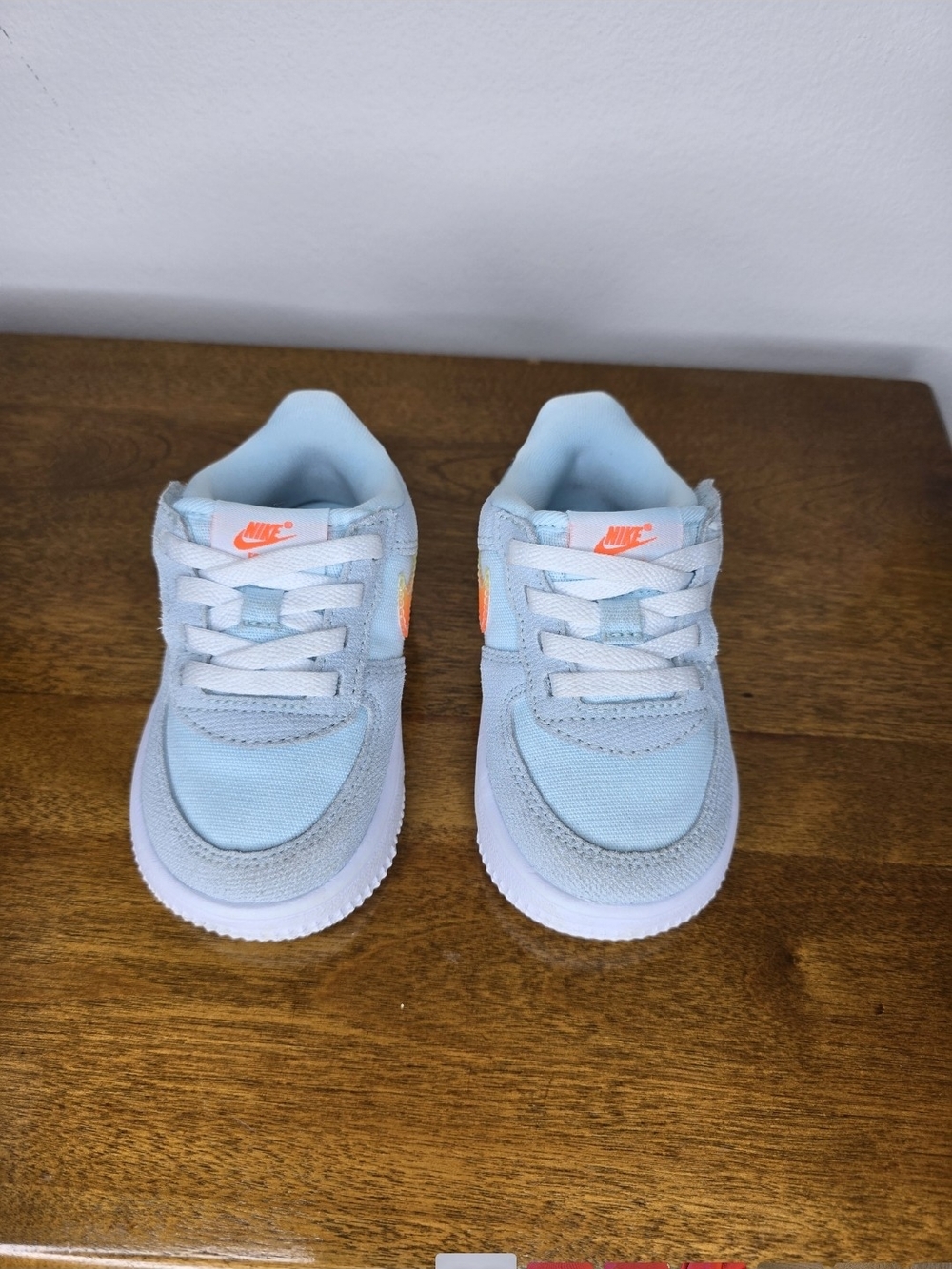 Nike Kids' Light Blue Sneaker with Orange Accents